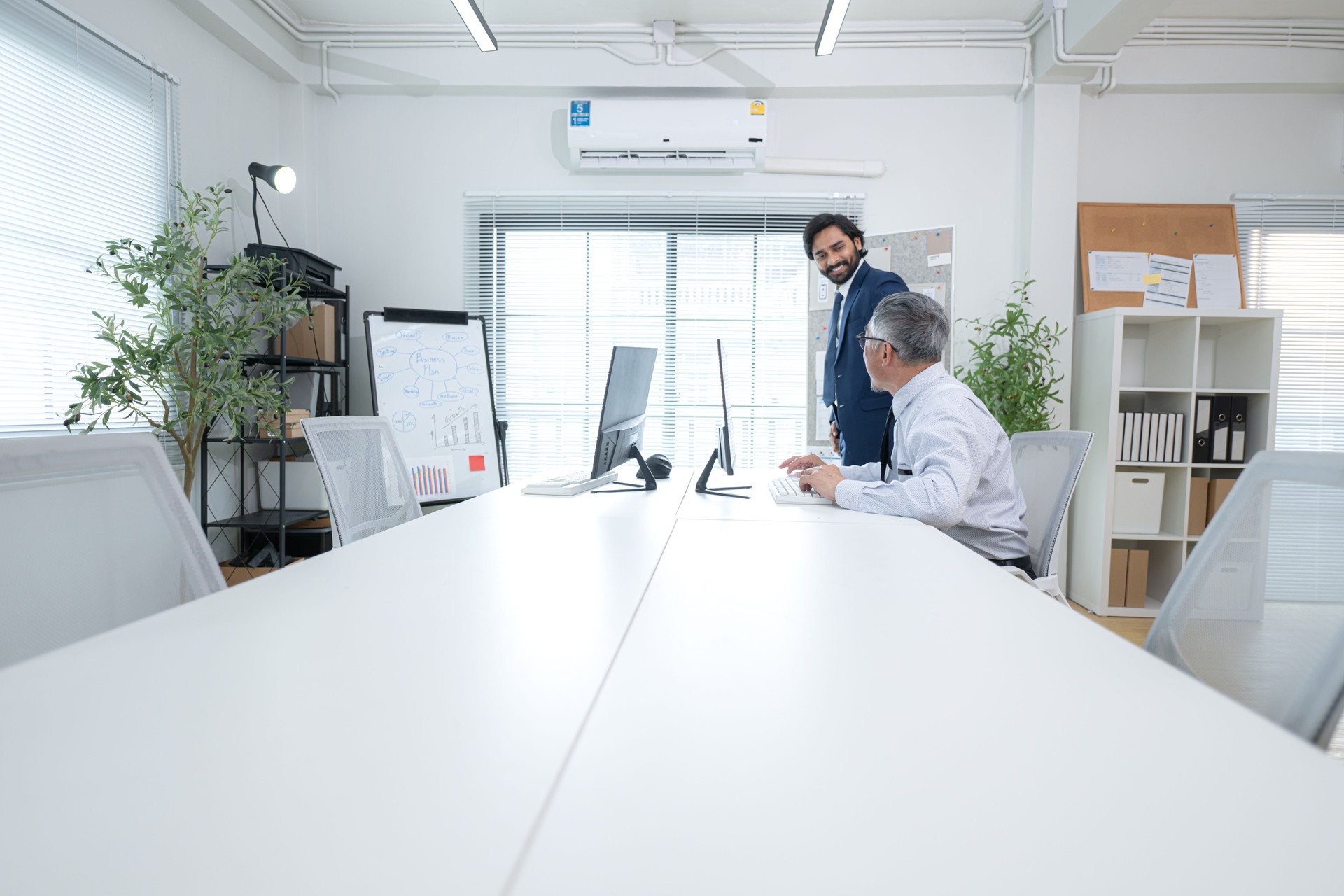 In a contemporary office, two senior executives with a mission to brainstorm and monitor the progress of a business project